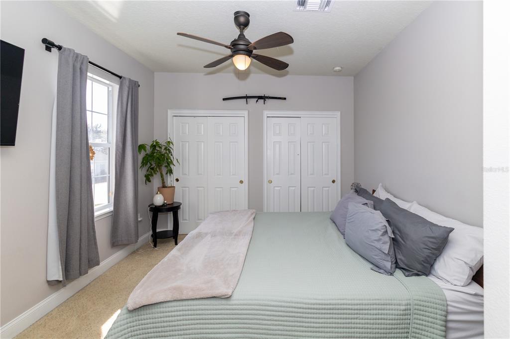 3305 Schoolhouse Road St. Cloud, FL 34773 - Photo 43 of 83 a bedroom with a bed and a chandelier
