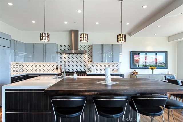 a kitchen with a table chairs and kitchen view
