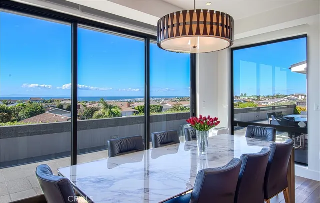 a dining room with furniture a chandelier and wooden floor