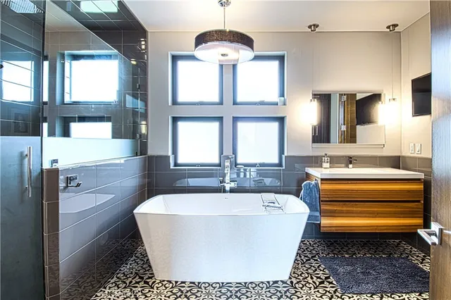 a bathroom with a bathtub sink and window