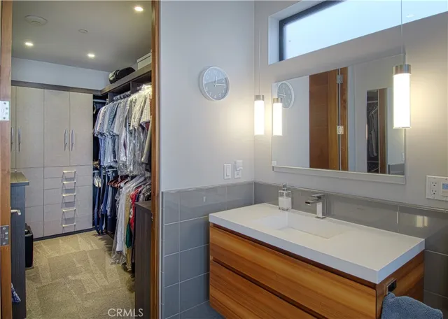 a bathroom with a sink mirror and shower