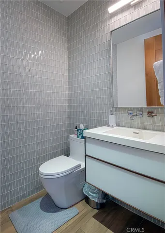 a bathroom with a sink a toilet and mirror