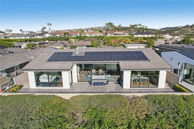 an aerial view of a house with garden space and outdoor seating