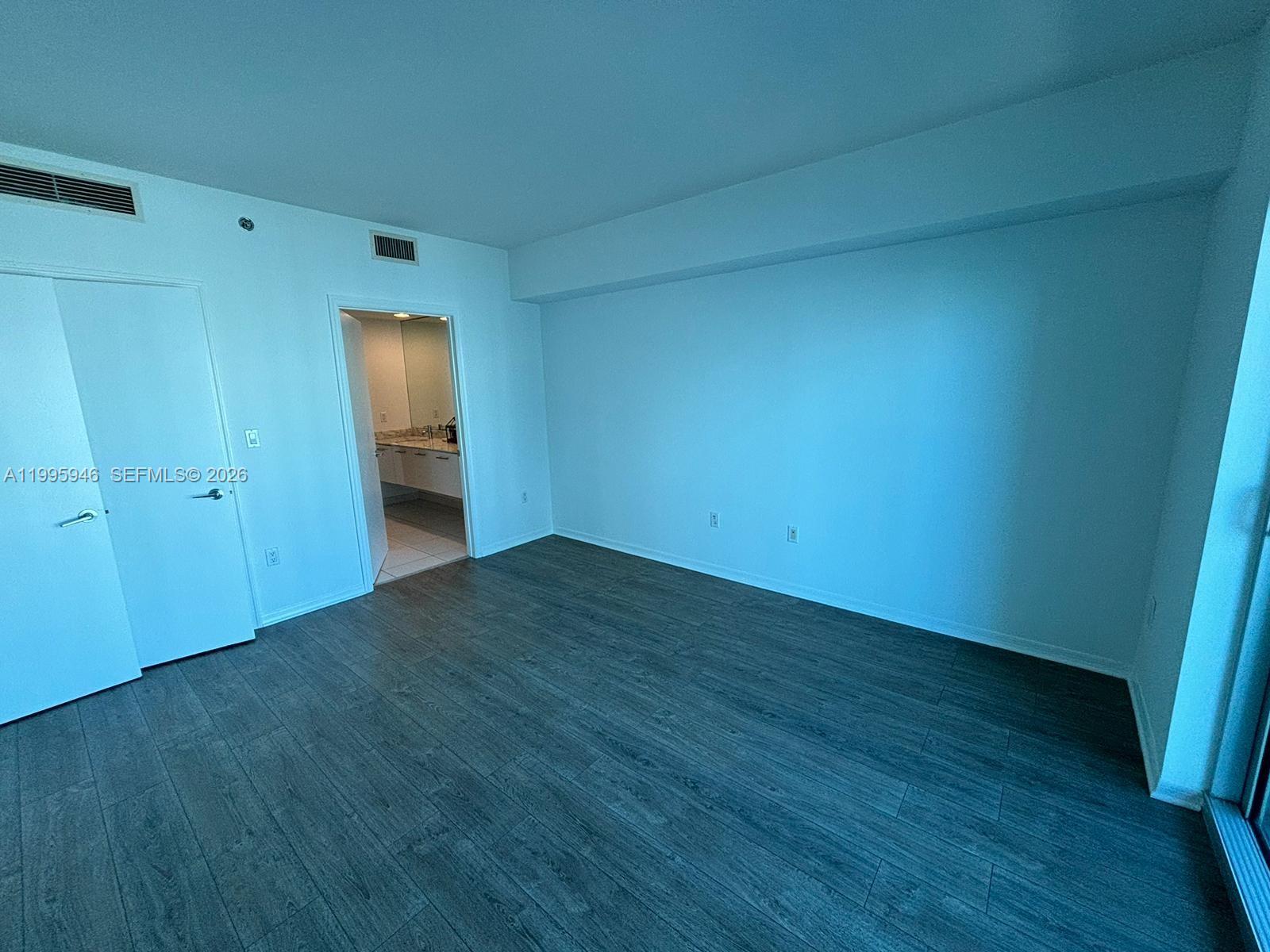 55 Southeast 6th Street, Unit 2005 Miami, FL 33131 - Photo 11 of 40 a view of empty room with wooden floor