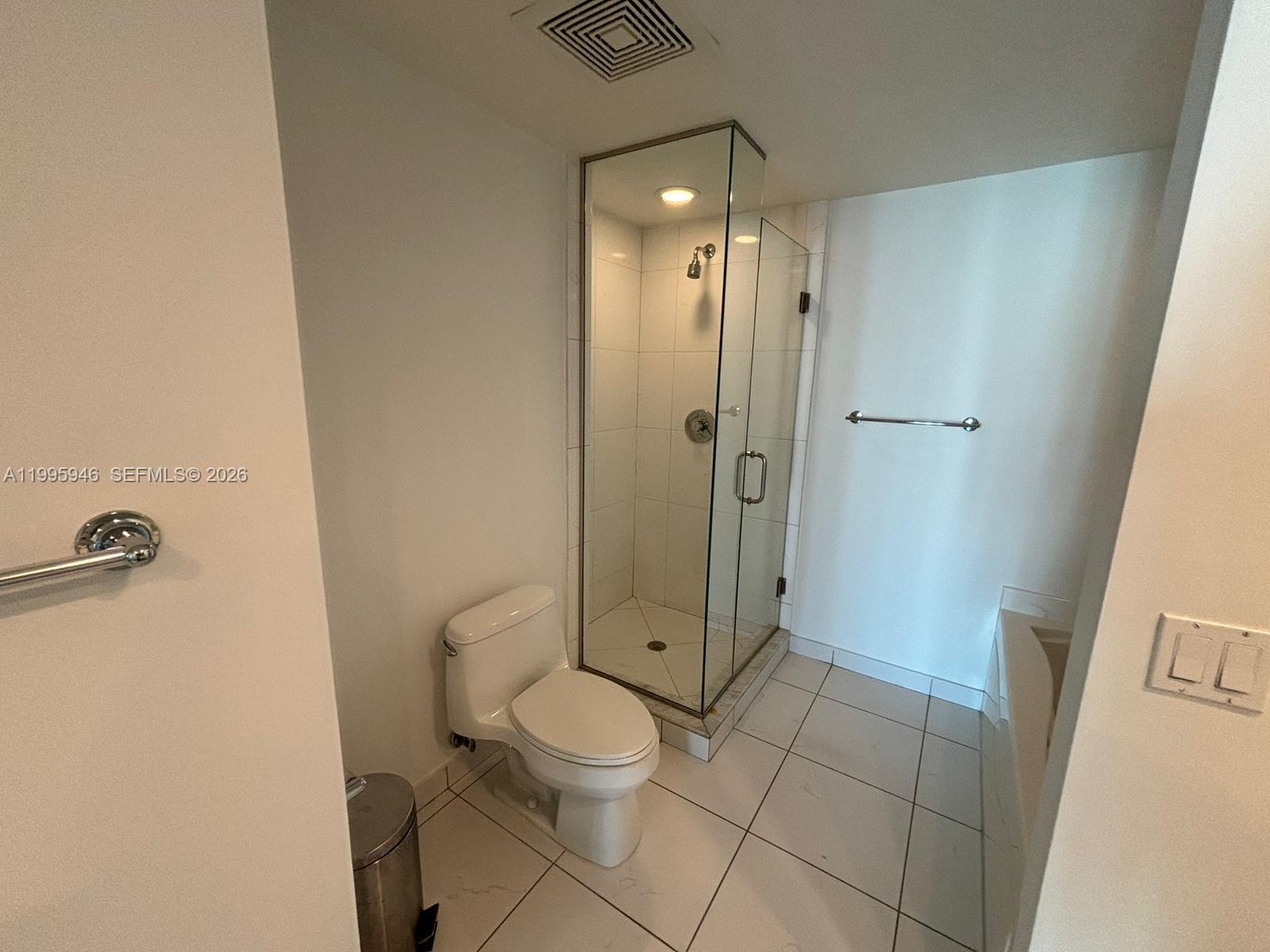 55 Southeast 6th Street, Unit 2005 Miami, FL 33131 - Photo 19 of 40 a bathroom with a toilet a sink and shower