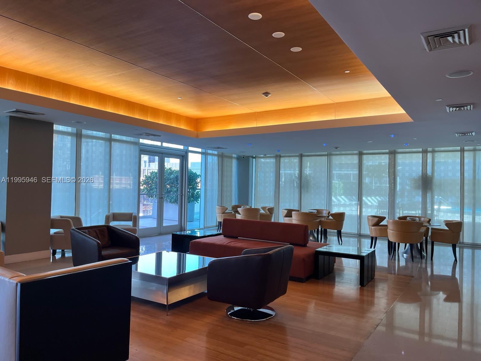 55 Southeast 6th Street, Unit 2005 Miami, FL 33131 - Photo 36 of 40 a living room with furniture and floor to ceiling windows