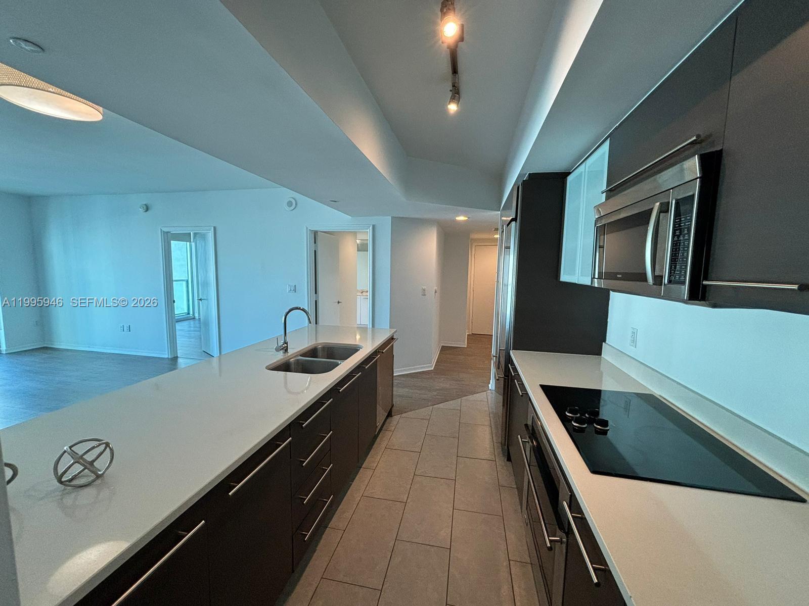 55 Southeast 6th Street, Unit 2005 Miami, FL 33131 - Photo 6 of 40 a large kitchen with stainless steel appliances a large counter top