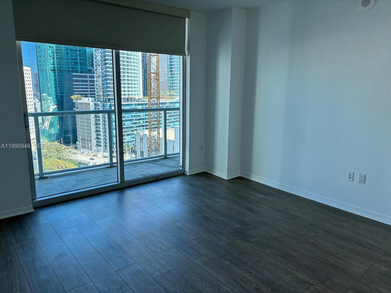 55 Southeast 6th Street, Unit 2005 Miami, FL 33131 - Photo 9 of 40 a view of a room with wooden floor and window