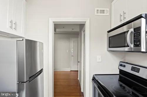 3742 12th Street Northeast, Unit 5 Washington, DC 20017 - Photo 4 of 8 a kitchen with a refrigerator and a stove