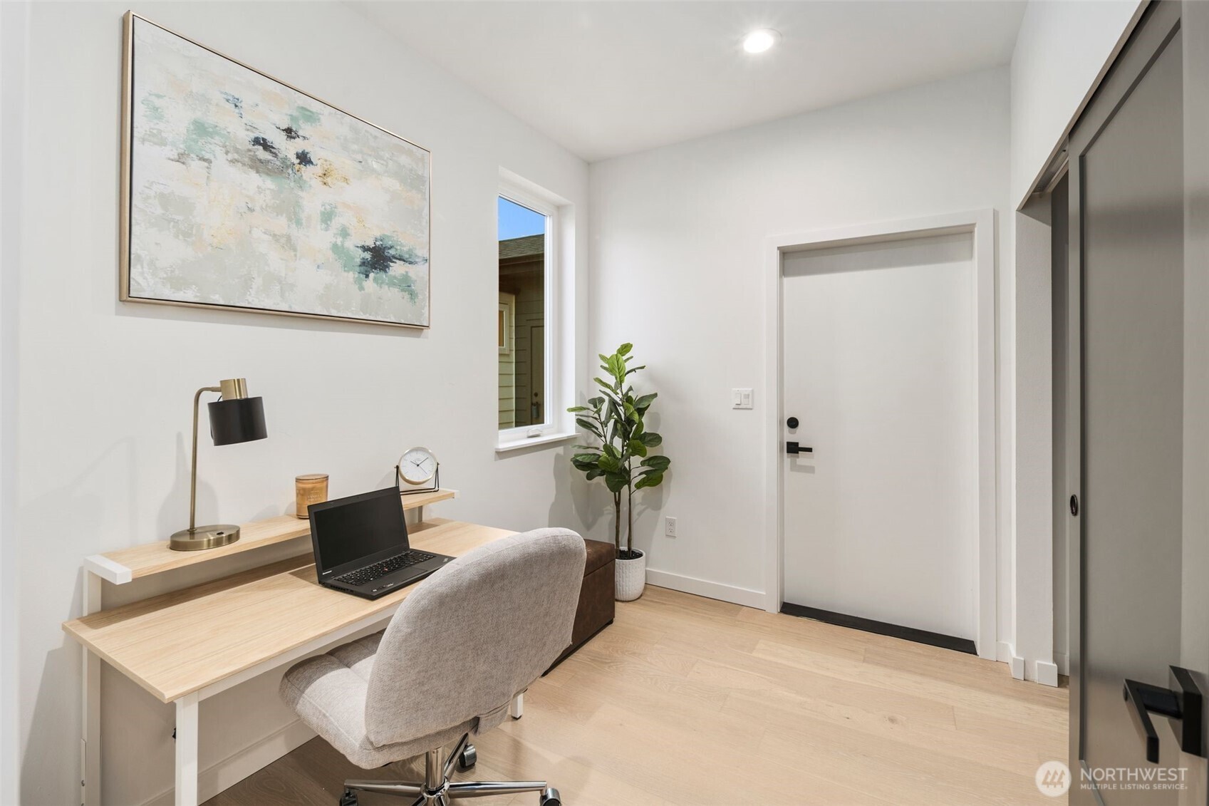 3807 Northeast 89th Street Seattle, WA 98115 - Photo 13 of 32 a view of a workspace with furniture and a potted plant