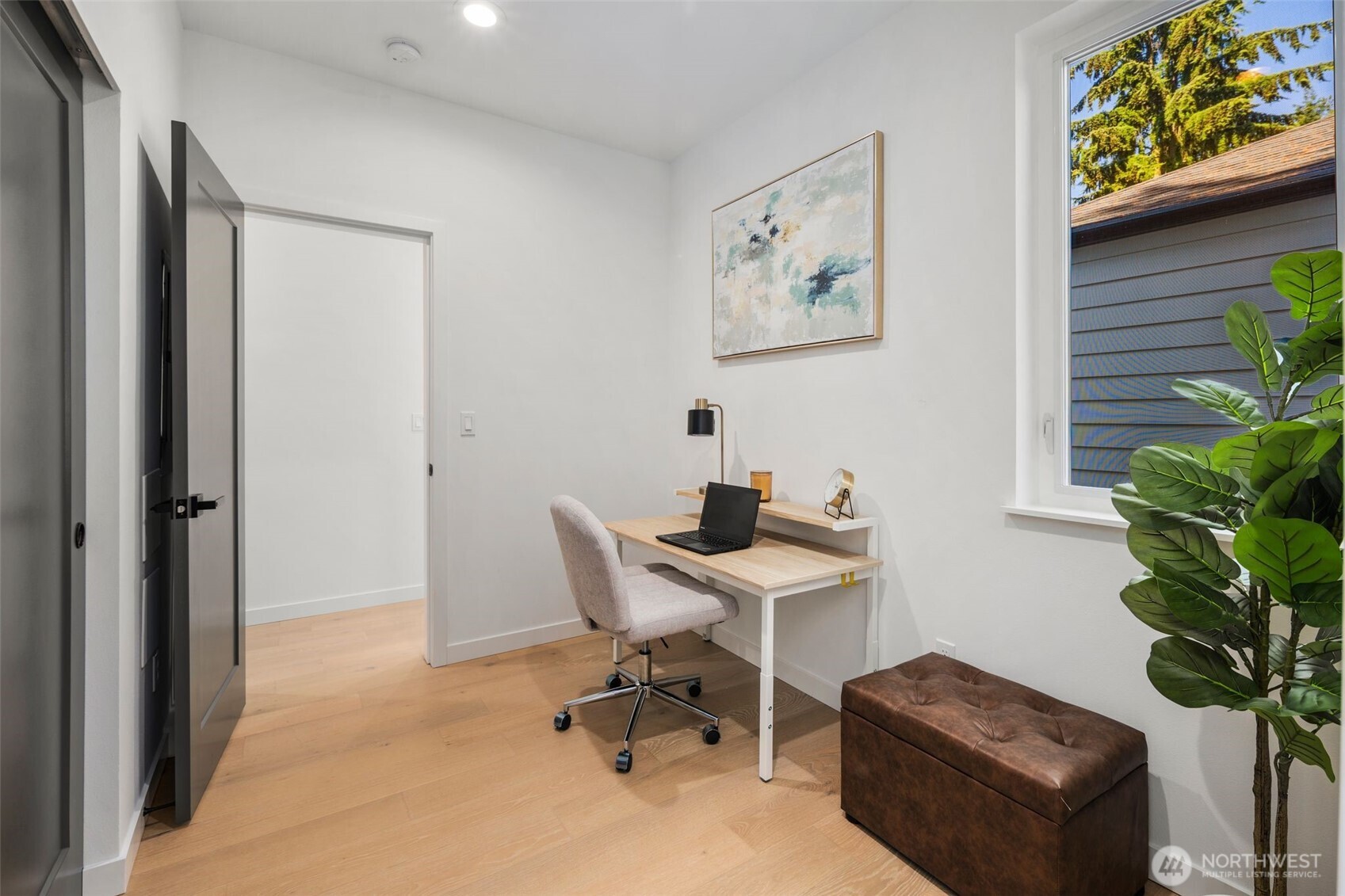 3807 Northeast 89th Street Seattle, WA 98115 - Photo 14 of 32 a view of a workspace with furniture and a potted plant