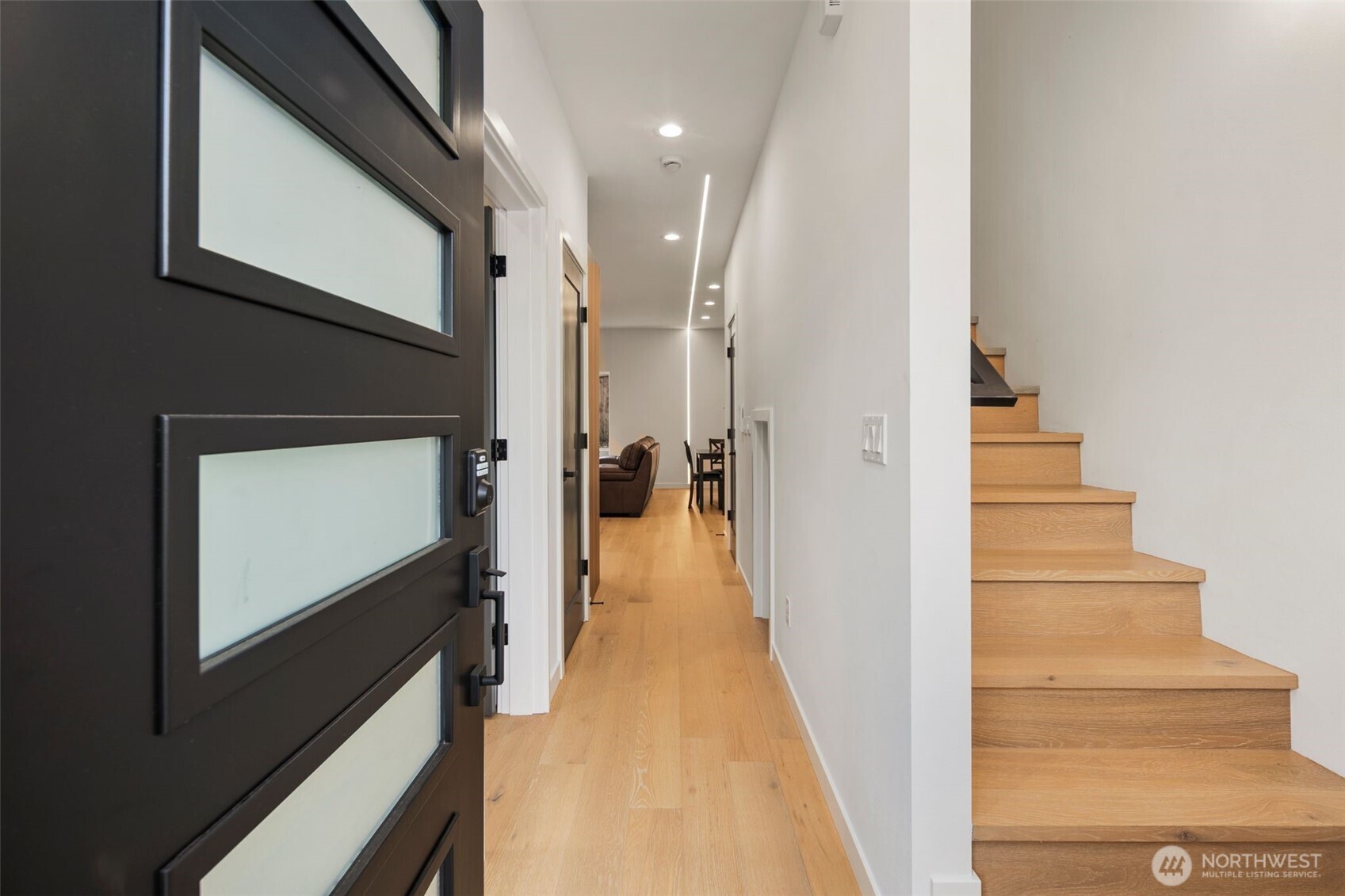 3807 Northeast 89th Street Seattle, WA 98115 - Photo 4 of 32 a view of a hallway with wooden floor and staircase