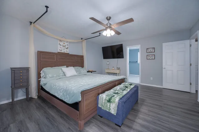 a bedroom with a large bed and a tv