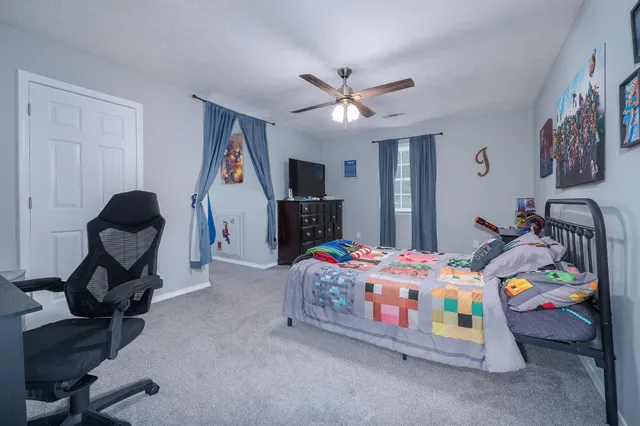 a bedroom with a bed and a chandelier