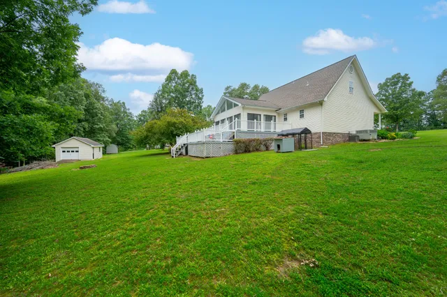 a aerial view of a house with yard and green space
