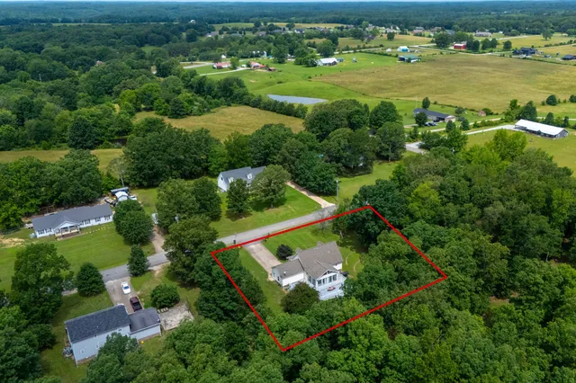 an aerial view of a houses with outdoor space and street view