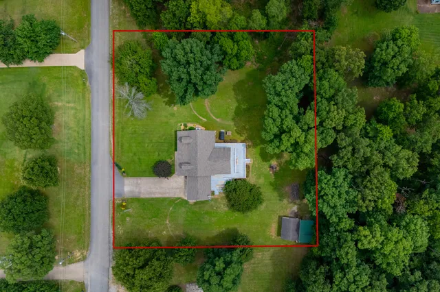 an aerial view of a house with a yard