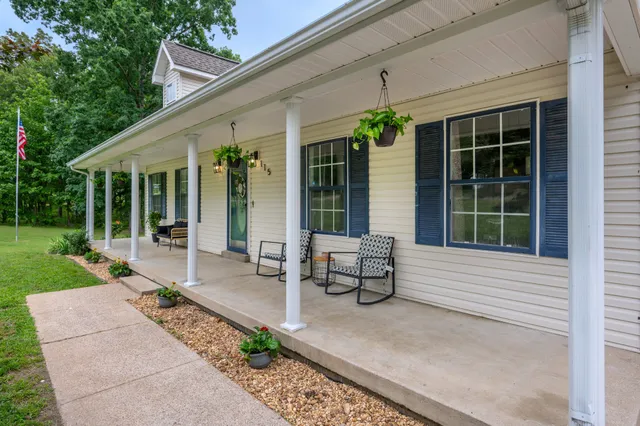 a view of a house with sitting area and garden