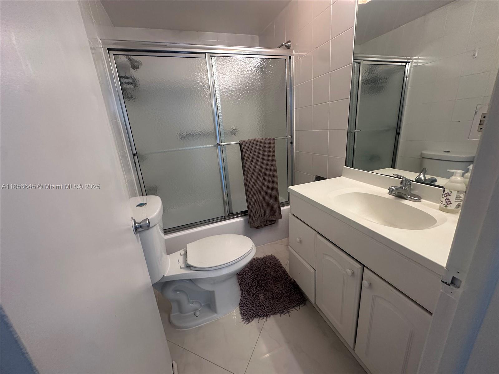 802 Euclid Avenue, Unit 305 Miami Beach, FL 33139 - Photo 7 of 13 a bathroom with a sink toilet and shower