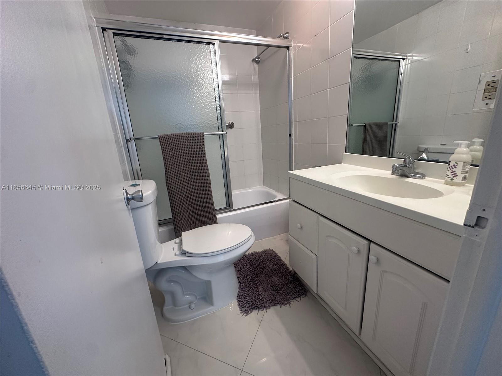 802 Euclid Avenue, Unit 305 Miami Beach, FL 33139 - Photo 8 of 13 a white toilet sitting next to a bathroom sink