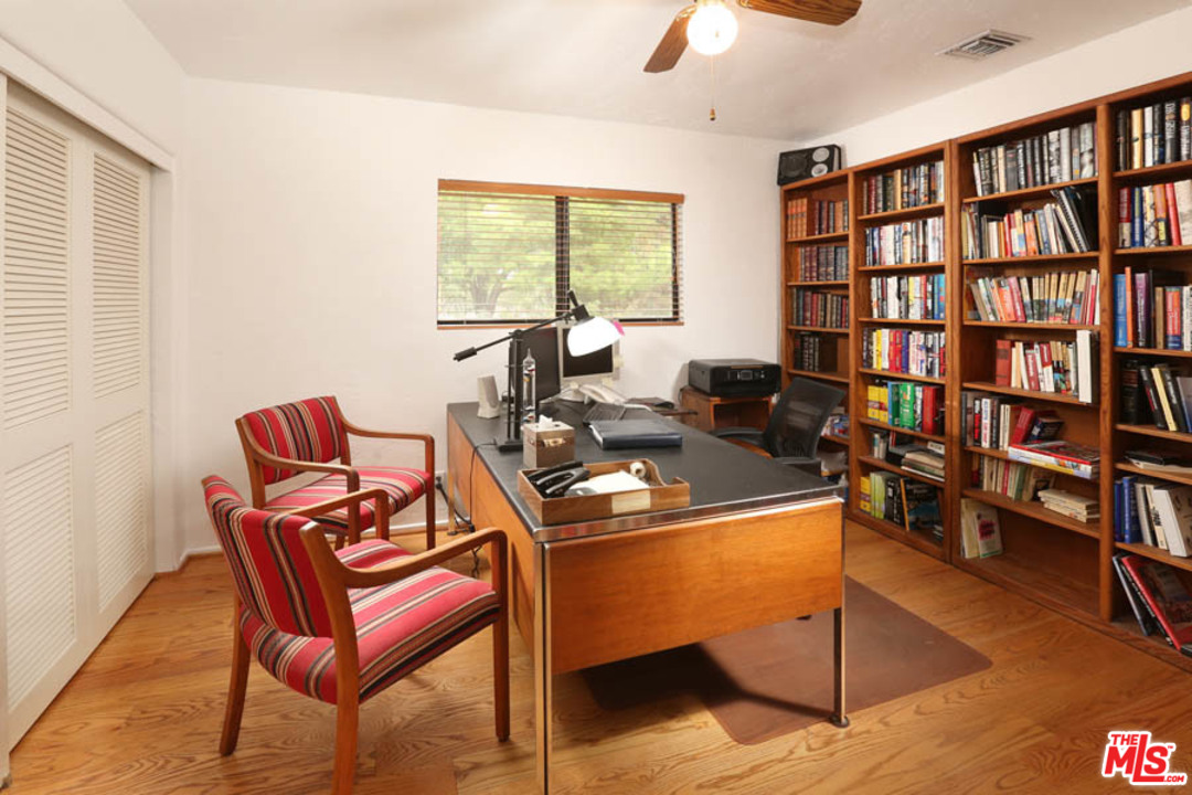 11345 Riverwood Drive Tujunga, CA 91042 - Photo 11 of 54 a living room with furniture a bookshelf and a window
