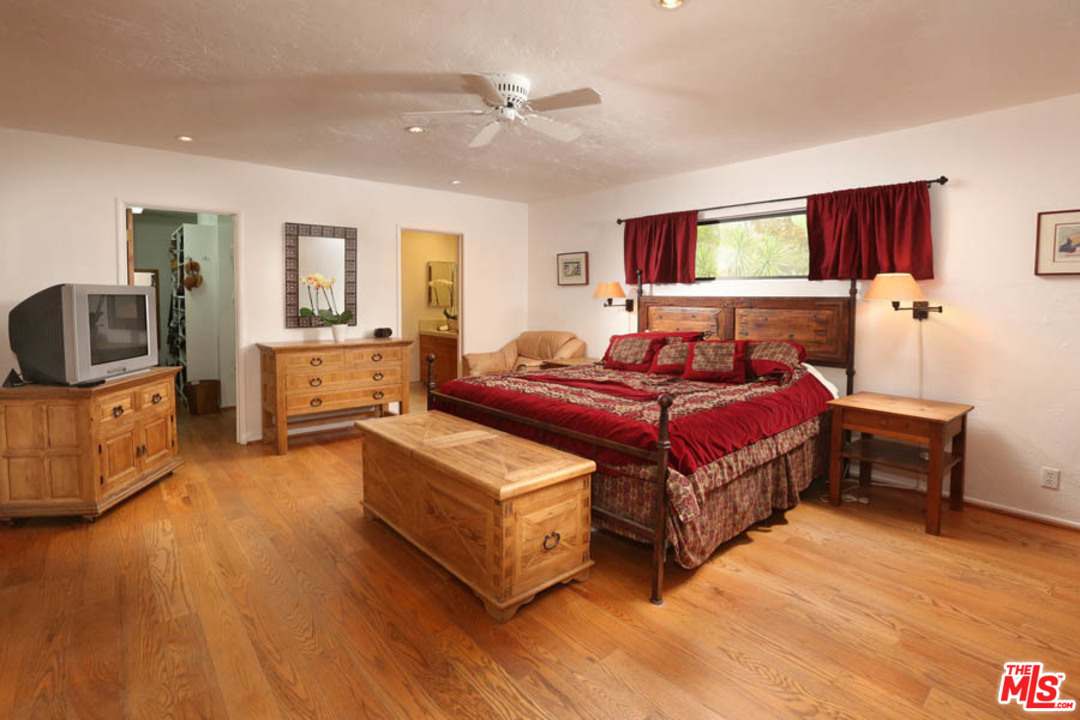 11345 Riverwood Drive Tujunga, CA 91042 - Photo 13 of 54 a spacious bedroom with a bed and wooden floor