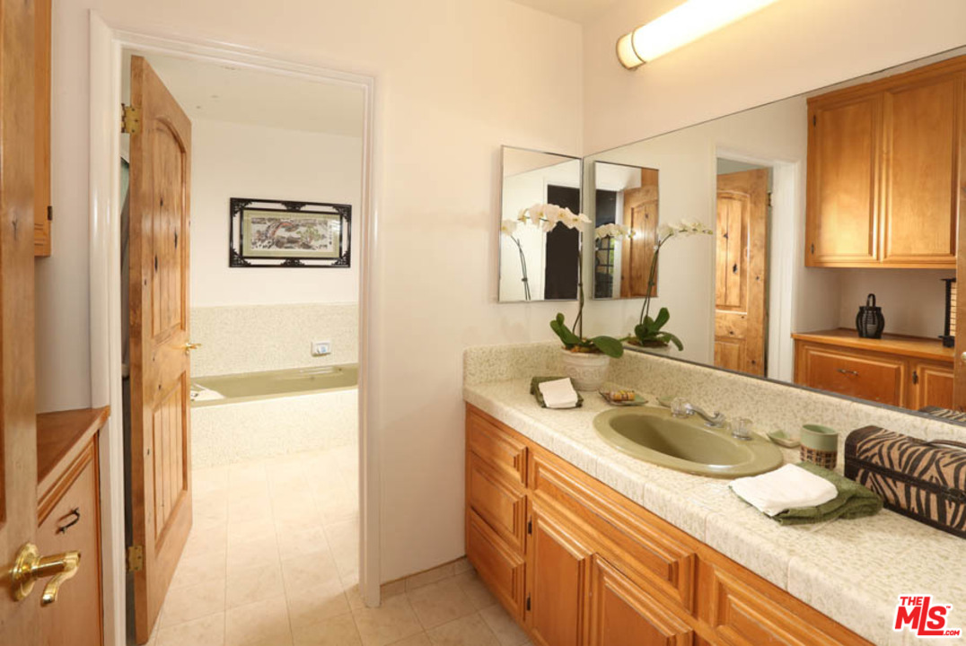 11345 Riverwood Drive Tujunga, CA 91042 - Photo 14 of 54 a bathroom with a sink and a mirror