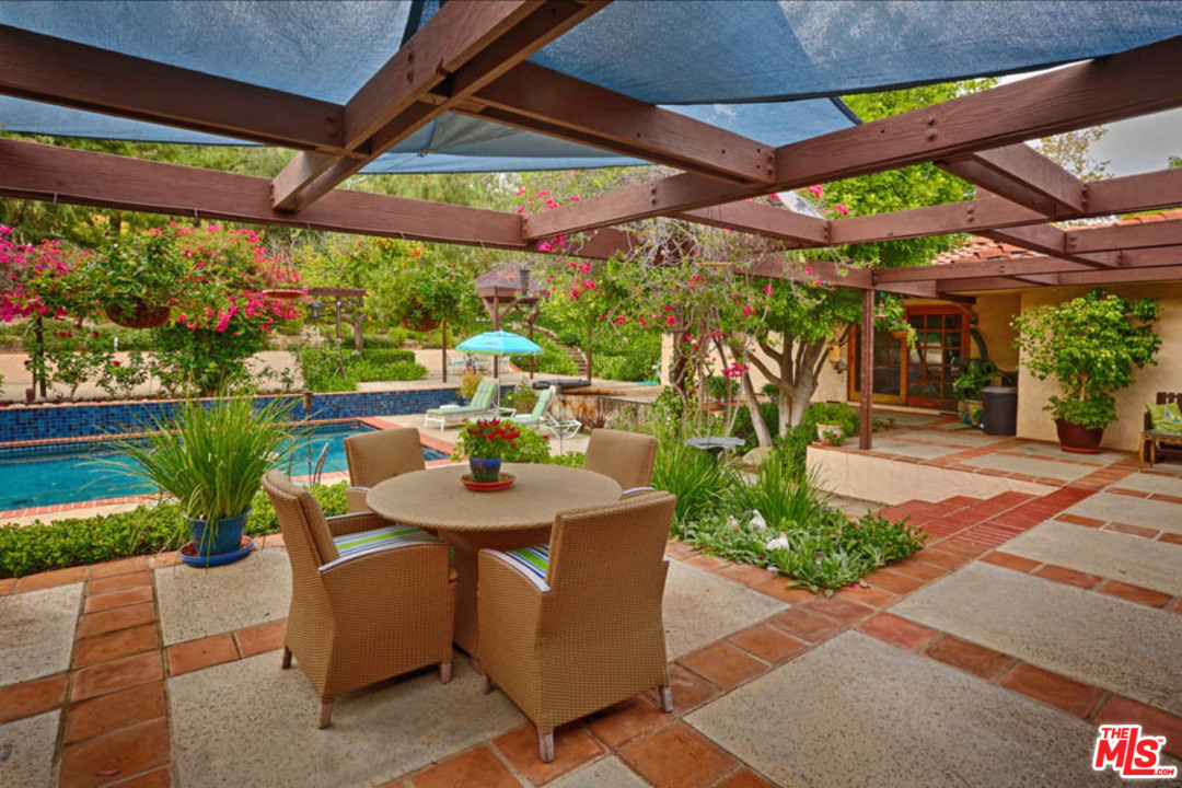 11345 Riverwood Drive Tujunga, CA 91042 - Photo 17 of 54 a view of a patio with table and chairs under an umbrella