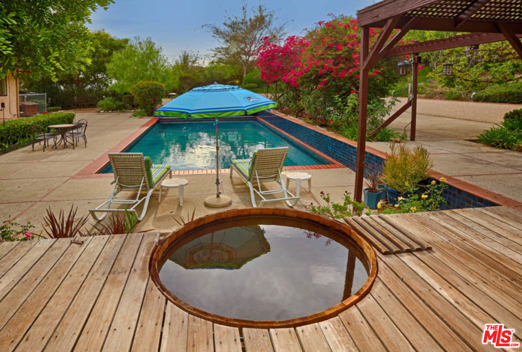 11345 Riverwood Drive Tujunga, CA 91042 - Photo 25 of 54 a view of a swimming pool with a patio