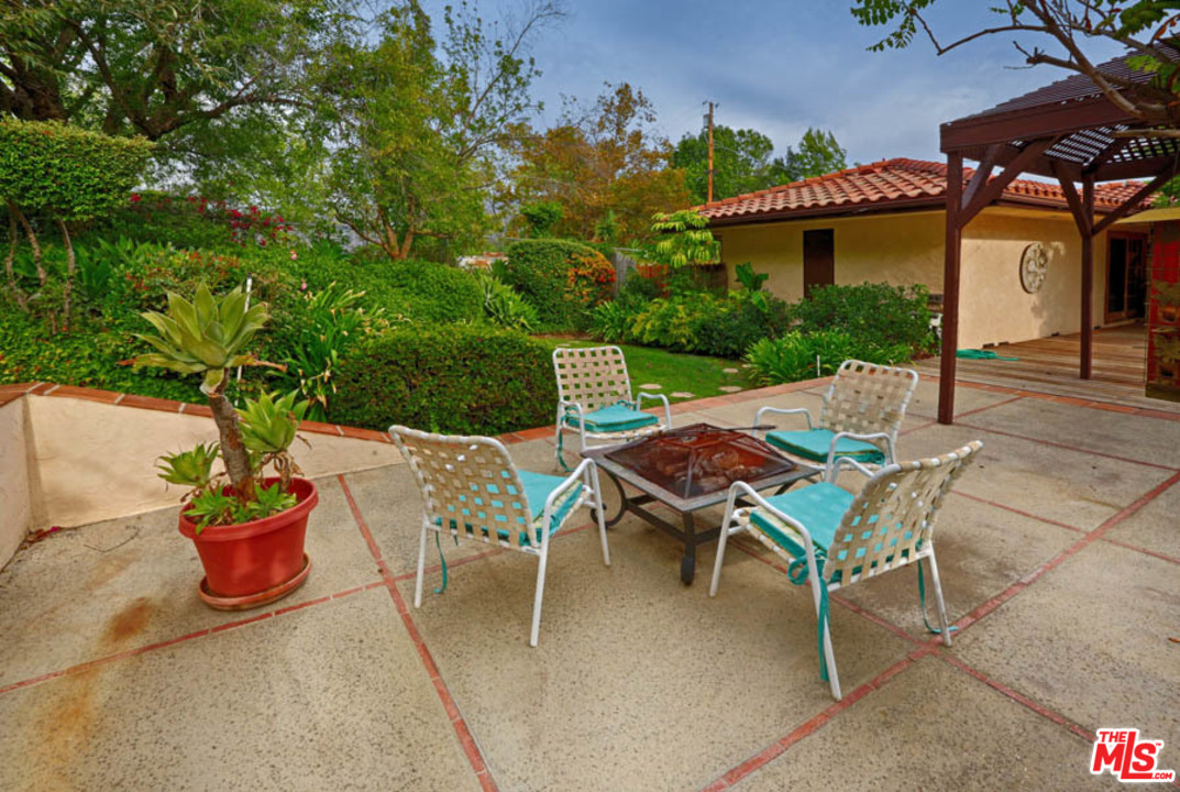 11345 Riverwood Drive Tujunga, CA 91042 - Photo 27 of 54 a view of a patio with table and chairs and potted plants