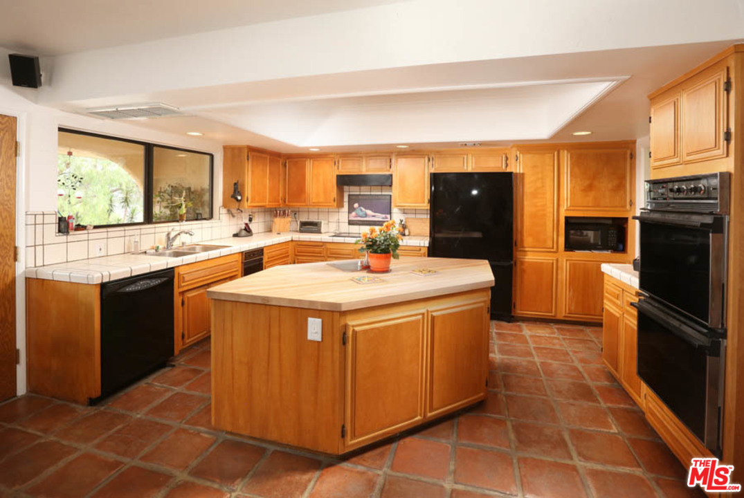 11345 Riverwood Drive Tujunga, CA 91042 - Photo 4 of 54 a kitchen with stainless steel appliances a sink stove and refrigerator