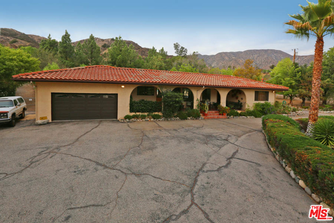 11345 Riverwood Drive Tujunga, CA 91042 - Photo 36 of 54 a view of a house with a yard and potted plants