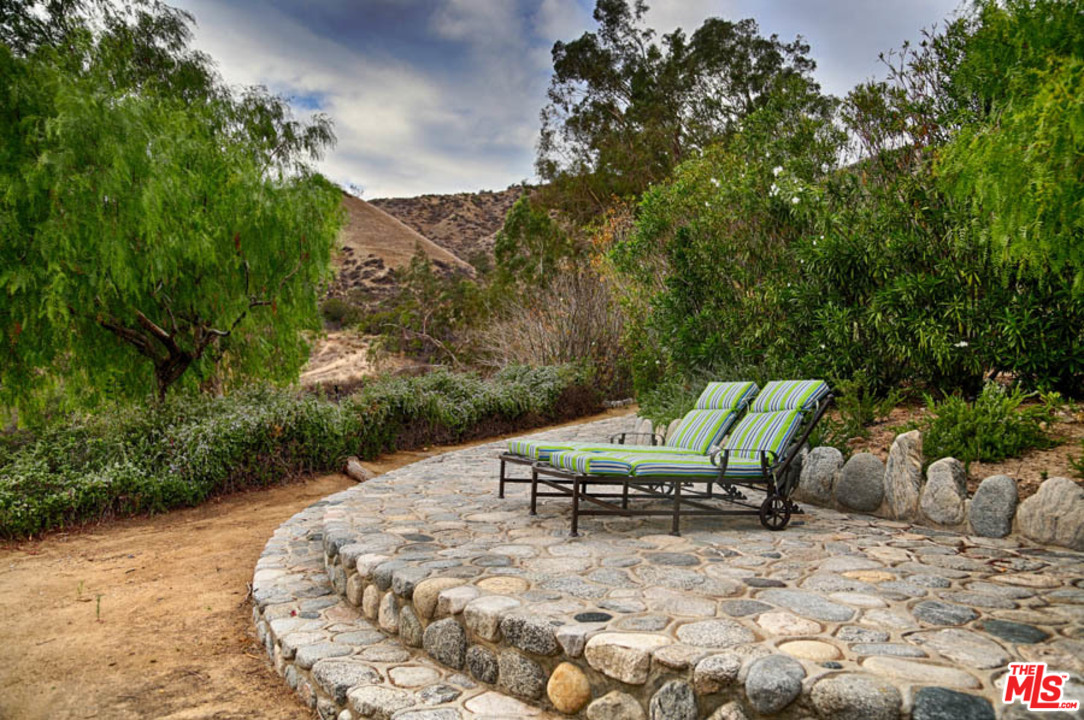 11345 Riverwood Drive Tujunga, CA 91042 - Photo 44 of 54 a view of a swimming pool with a lounge chair
