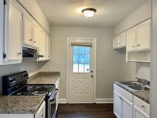 a kitchen with stainless steel appliances granite countertop a stove and a sink