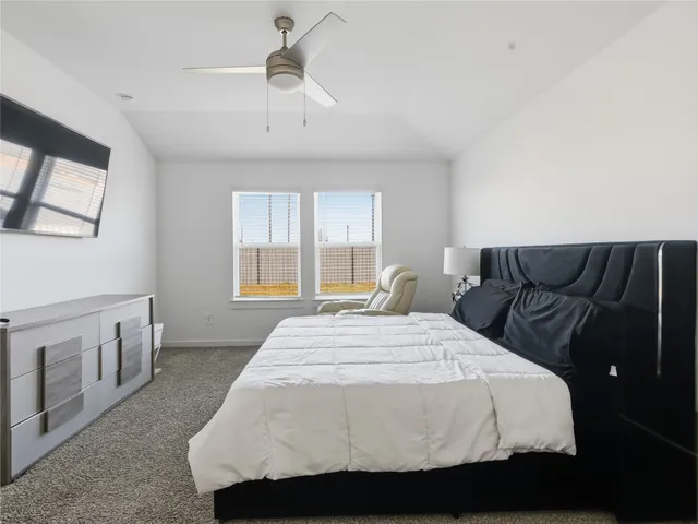 a bedroom with a bed and window