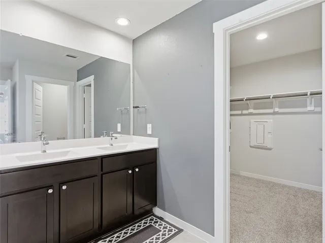 a bathroom with a double vanity sink a and mirror
