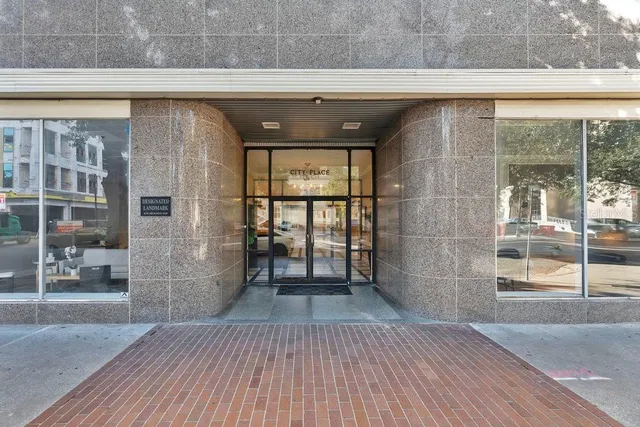 a hallway with a wooden floor and a fireplace