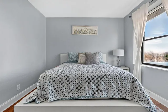 a bedroom with a bed and window