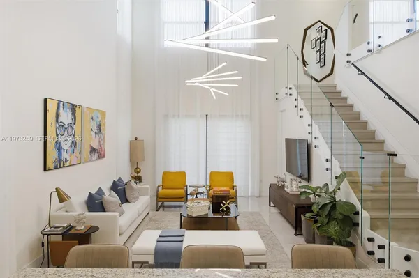 a living room with furniture a clock and a chandelier