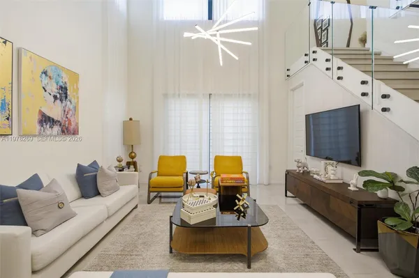 a living room with furniture fireplace and a chandelier