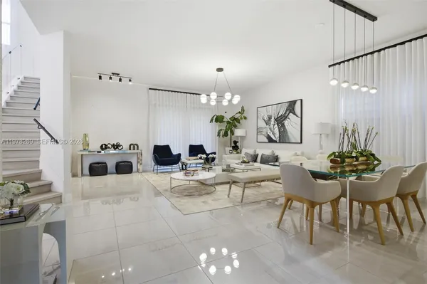 a living room with furniture and a chandelier