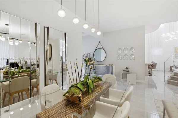a living room with lots of furniture and a chandelier
