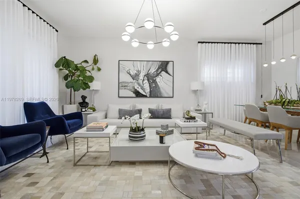 a living room with furniture and a chandelier