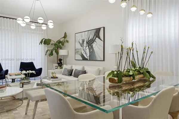 a living room with furniture and a chandelier