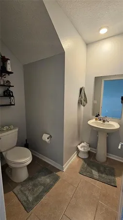 a bathroom with a toilet and a mirror