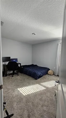 a bedroom with a bed and a desk