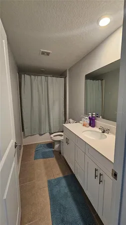 a bathroom with a double vanity sink and mirror