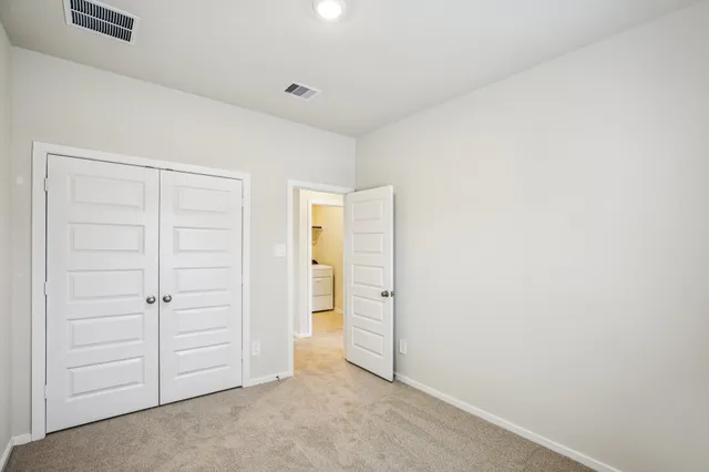 an empty room with closet area