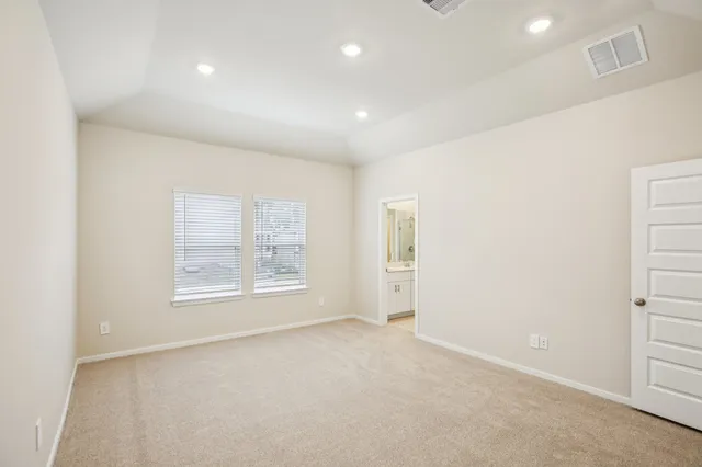 an empty room with windows and closet