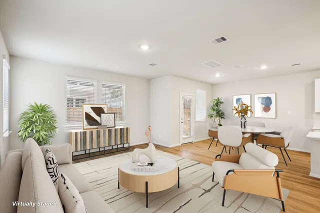 a living room with furniture and a potted plant